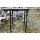A WROUGHT IRON AND GLASS TOP GARDEN  TABLE. 2ft 5ins high x 3ft 0ins wide.