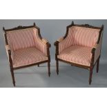 A GOOD PAIR OF FRENCH CARVED BEECH WOOD ARMCHAIRS with striped upholstery on turned legs.