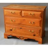 A PINE STRAIGHT FRONT CHEST OF TWO SHORT AND THREE LONG GRADUATED DRAWERS with brass handles on