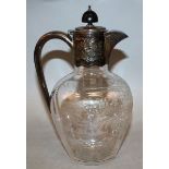 A VICTORIAN CUT GLASS CLARET JUG, birds, flowers and scrolls with silver handle, band and lid 8.5ins