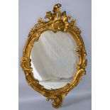 A GOOD 19TH CENTURY FRENCH GILT OVAL MIRROR in a scrolled acanthus frame. 3ft 11ins high, 2ft 6ins