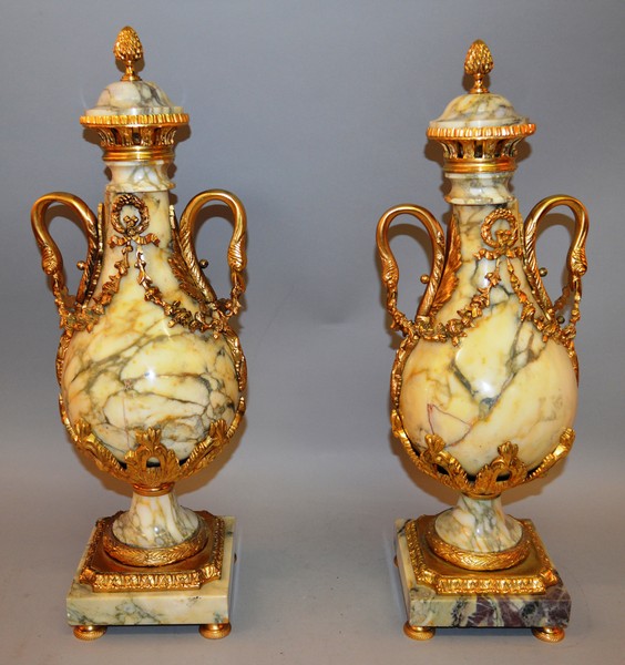 A SUPERB PAIR OF LOUIS XVI VIENNA MARBLE AND ORMOLU MOUNTED TWO HANDLED URNS AND COVERS with applied