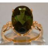 A LARGE GREEN STONE DRESS RING set in 9ct gold.