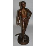 A SUPERB REGENCY BRONZE CUPID with bow and arrow standing on a porphyry circular base. 12.5ins