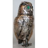 A CONTINENTAL SILVER .800 STANDING OWL with hinged head and glass eyes 5ins high.