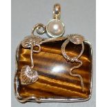 A SILVER MOUNTED AMBER PENDANT.