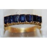 A GOOD SEVEN STONE SAPPHIRE RING in 22ct yellow gold.