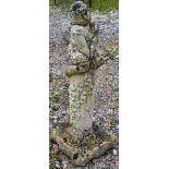 A RECONSTITUTED STONE GARDEN ORNAMENT modelled as a girl seated on a column 2ft 9ins high.