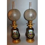 A GOOD PAIR OF 19TH CENTURY FRENCH PORCELAIN OIL LAMPS AND SHADES, the blue bodies with reverse