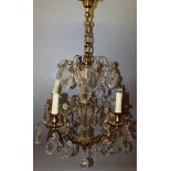 A 19TH CENTURY FRENCH GILT METAL AND GLASS CHANDELIER with cut glass drops and five candle