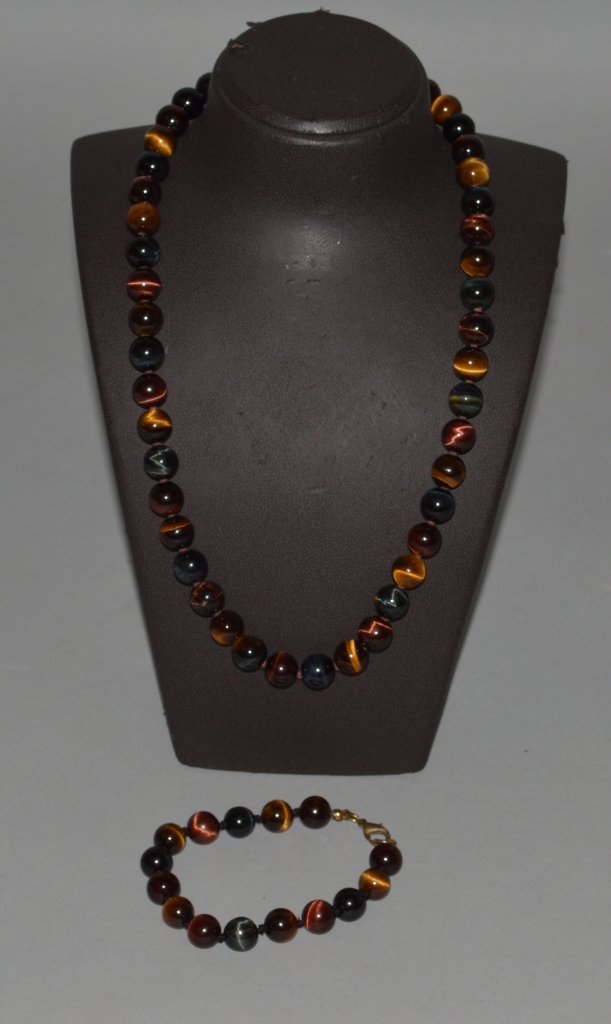 A TIGERS EYE NECKLACE of forty-five beads and a BRACELET of fifteen beads.