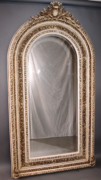 A LARGE UPRIGHT WHITE AND GILT FRAMED MIRROR with bevelled mirrored panel. 7ft high, 3ft 5ins wide.