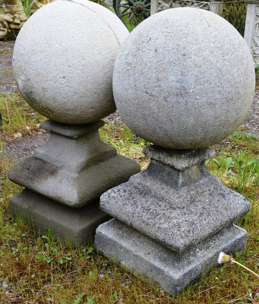 A PAIR OF RECONSTITUTED STONE BALL GATEPOST FINIALS 1ft 9ins high.