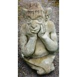 A RECONSTITUTED STONE GARDEN ORNAMENT modelled as a  Gargoyle 1ft 6ins high.