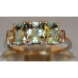 A GOOD THREE GREEN STONE AND DIAMOND RING set in 9ct gold.