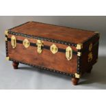 A BRASS BOUND TRUNK converted into a coffee table on turned legs. 2ft wide.