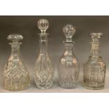 FOUR VARIOUS DECANTERS AND STOPPERS.