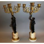 A SUPERB PAIR OF REGENCY BRONZE AND ORMOLU THREE LIGHT CANDELABRA formed as bronze classical figures