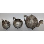 AN INDIAN SILVER THREE PIECE TEA SET, the teapot and milk jug with elephant handles, the whole of