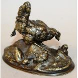 A GOOD SMALL BRONZE GROUP OF A CHICKEN WITH CHICKS on an oval base. 4.25ins long, 3.5ins high/