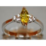 A YELLOW STONE AND DIAMOND RING set in 9ct gold.