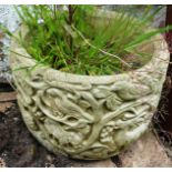 A SMALL RECONSTITUTED STONE GARDEN PLANTER with moulded decoration 8ins high.