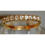 A NINE STONE HALF ETERNITY RING set in 9ct gold.