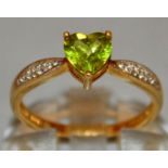 A GREEN TEARDROP STONE RING with diamond shoulders, set in 9ct gold.