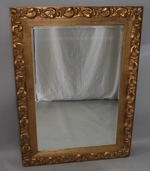 A LARGE GILTWOOD FRAMED MIRROR with acanthus  decoration. 3ft 9ins x 2ft 8ins.