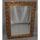 A LARGE GILTWOOD FRAMED MIRROR with acanthus  decoration. 3ft 9ins x 2ft 8ins.