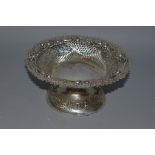 A SILVER EMBOSSED CIRCULAR TAZZA with loaded base.