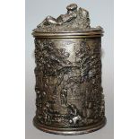 A GOOD CONTINENTAL PLATE CIRCULAR TOBACCO JAR AND COVER, figures in relief merrymaking 7ins high.