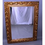 A GILT UPRIGHT MIRROR with acanthus and reeded frame. Overall Size 3ft 9ins x 2ft 9ins.