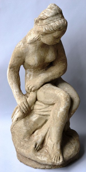 A RECONSTITUTED STONE FIGURE OF A SEATED FEMALE NUDE 2ft 0ins high.