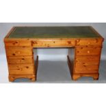 A GOOD PINE RECTANGULAR TOP PEDESTAL DESK with inset leather top, three frieze drawers, drawers to