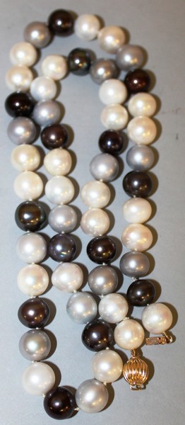 A STRING OF BLACK AND WHITE PEARLS.
