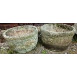 A PAIR OF RECONSTITUTED STONE GARDEN PLANTERS of moulded circular form 10ins high.