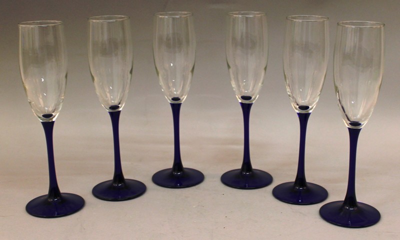 A SET OF SIX WINE GLASSES with blue stems.