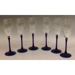 A SET OF SIX WINE GLASSES with blue stems.