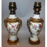 A GOOD PAIR OF 19TH CENTURY SAMSON PORCELAIN FAMILLE ROSE VASES converted to lamps with ormolu