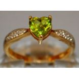 A GREEN STONE AND DIAMOND RING set in 9ct gold.