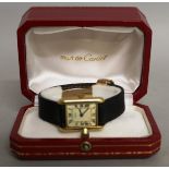 A VERY GOOD LADIES CARTIER GOLD WRISTWATCH and leather strap in a Cartier red and gold box.