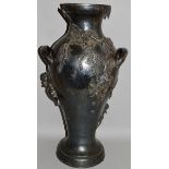 A LARGE WMF PEWTER TWO HANDLED VASE with cupids, thistle and flowers in relief 26.5ins high.