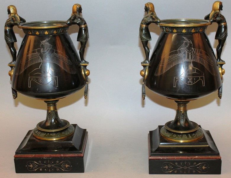 A GOOD PAIR OF 19TH CENTURY “EGYPTIAN DESIGN” TWO HANDLED URNS on marble stands with Egyptian figure