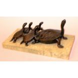 A BRONZE GROUP OF A TURTLE WITH FOUR YOUNG on a green marble base. 8ins long.