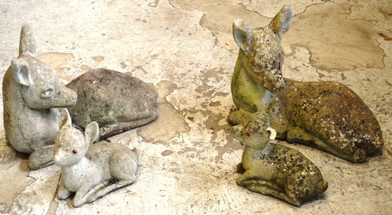 A PAIR OF GARDEN ORNAMENTS modelled as recumbent deer; together with a similar smaller pair. Various