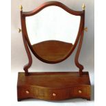A GEORGIAN STYLE MAHOGANY SERPENTINE FRAMED TOILET MIRROR with shield shaped mirror and three