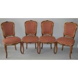 A SET OF FOUR BEECH FRAMED AND UPHOLSTERED SIDE CHAIRS with floral covered decoration.