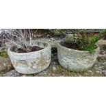 A PAIR OF RECONSTITUTED STONE GARDEN PLANTERS of moulded circular form 10ins high.