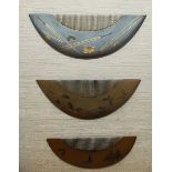 A SET OF THREE JAPANESE LACQUER COMBS in a glass case. 9.5ins x 7.5ins.